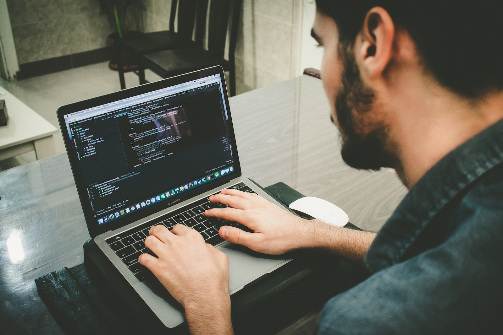 man programming using laptop